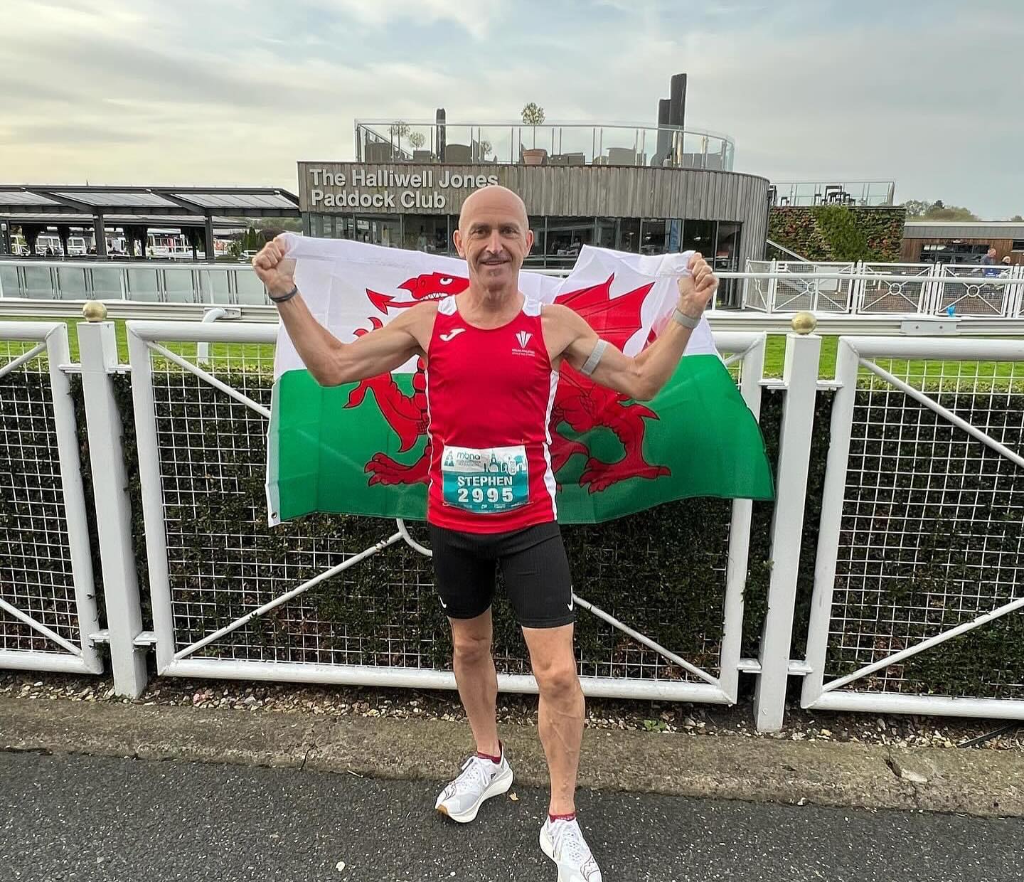 Steve holding the Welsh flag after a marathon